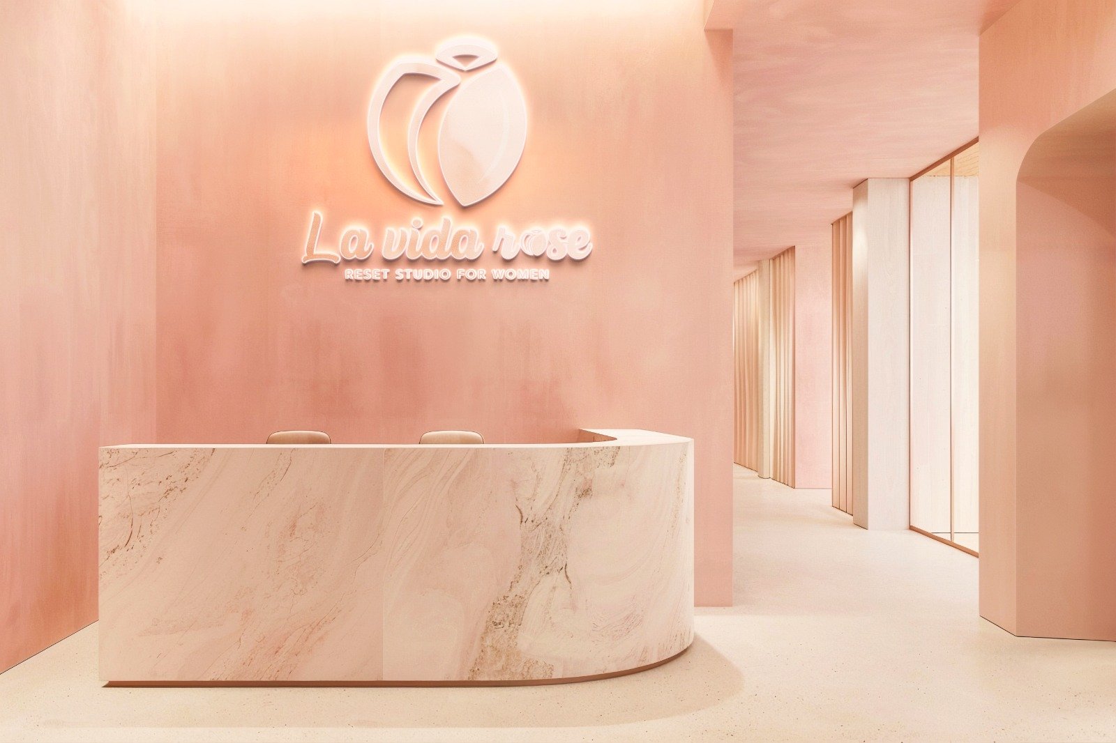 Peach-lit reception with La Vida Rose signage